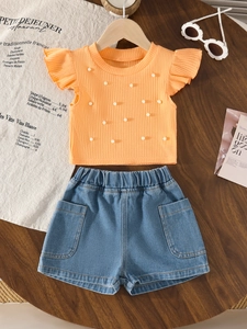 Girls' summer set with orange beaded knit top, flutter sleeves, and denim shorts