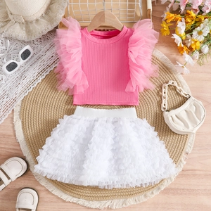 Detail of pink ruffled knit top and white layered mesh tutu skirt set for girls