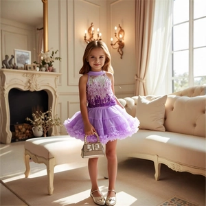Detail of girls purple sequin princess top and layered tutu skirt with gold handbag