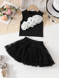 Detailed flat lay of girls' black tutu skirt set with 3D white floral applique vest