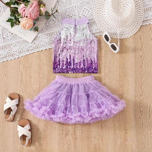 Flat lay of purple sequin halter top and layered mesh tutu skirt for young girls