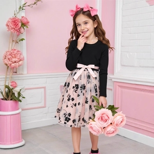 Detail of girls' long-sleeve dress featuring a pink bow and floral mesh skirt
