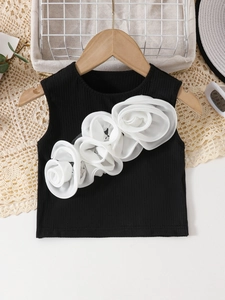 Close-up of girls black ribbed knit vest featuring four large 3D white chiffon flowers