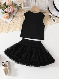 Flat lay detail of girls black ribbed top and layered tutu skirt set on wood hanger
