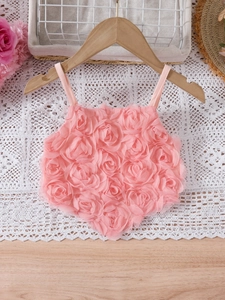 Pink toddler tutu dress with 3D rose floral texture on a delicate wooden hanger