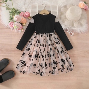 Flat-lay detail of girls' cold-shoulder knit top and floral mesh skirt with accessories