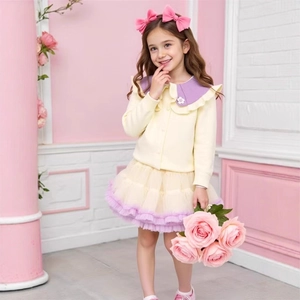Detail of yellow knit cardigan with purple floral collar and mesh tutu skirt