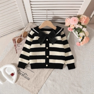 Detail of girls striped knit cardigan featuring a sailor collar and large black bow accent