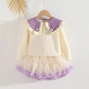 Detail of knit cardigan with purple ruffle collar and matching tutu skirt set
