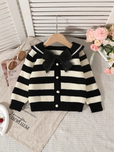 Girls' black and white striped knit cardigan with navy collar and large bow detail