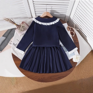 Close-up of navy toddler girls' suit with lace collar and pleated skirt detail