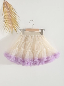 Elegant cream tutu skirt with purple trim hanging on wooden hanger for girls