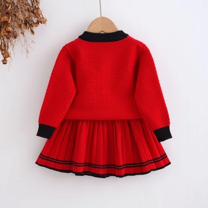 Detailed knit texture and honeycomb weave of a red and black girl's sweater set