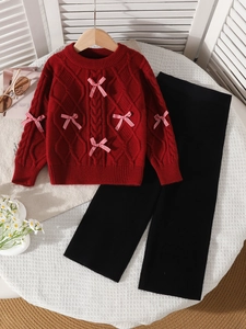 Red knit cable sweater with checkered bows and black wide-leg pants for girls