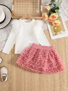 Detailed flat lay of girls' two-piece set with white ribbed top and pink tulle tutu skirt