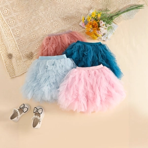 Detailed flat lay of multi-layered tulle tutu skirts in pastel colors for girls