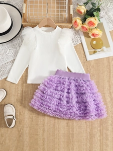 Flat lay of girls long sleeve ribbed top with purple layered tulle tutu skirt
