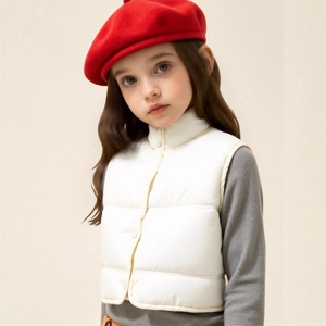 Detail of white puffer vest with snap buttons and high collar for kids