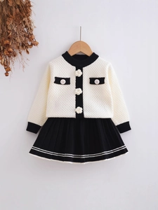 Girls' white knitted cardigan with camellia buttons and black pleated skirt set