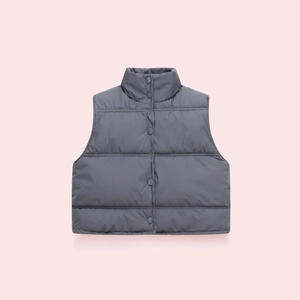 Close-up of dark grey quilted children's vest with stand collar and snap buttons