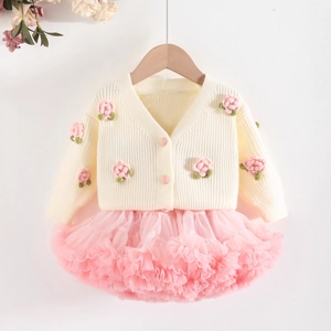 Detail of girls' knit cardigan with floral crochet and pink layered tulle tutu skirt