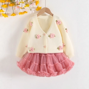 Detail of toddler crochet rose cardigan and layered pink tutu tulle skirt set