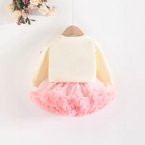 Detail of baby girl cream knit cardigan and layered pink tutu skirt set for toddler