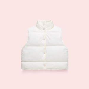 Detailed view of cream puffer vest featuring horizontal quilting and color-matched buttons