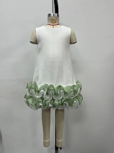 Detail of multi-layered green and white ruffled hem on sleeveless summer dress