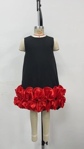 Detailed close-up of double-layer red satin flower ruffles on a black sleeveless dress