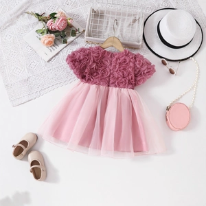 Detail view of pink girls dress with 3D rose embroidery and layered tulle skirt