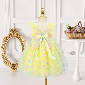 Detail of a yellow fairy tutu dress featuring 3D butterfly appliqués and mesh layers