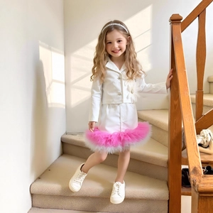 Detail of girls white blazer and matching tutu skirt with vibrant pink mesh trim detail