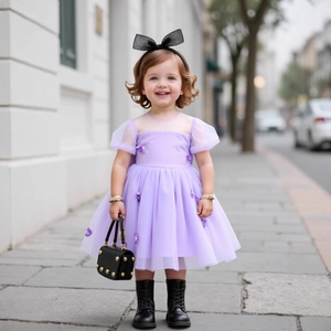 Detailed close-up of purple tulle dress with 3D butterfly appliques and puffed sleeves