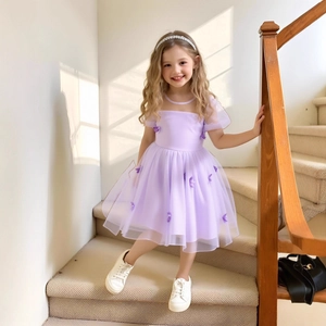 Detail of light purple tulle princess dress with 3D butterfly appliqués and puff sleeves
