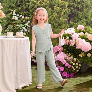 Detail of girls sleeveless V-neck top and wide-leg trousers in light sage green