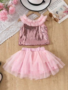 Girls pink sequin two-piece set with mesh cake skirt and lace ruffles on wooden floor