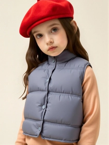 Kids quilted puffer vest in dusty blue featuring stand collar and button closure