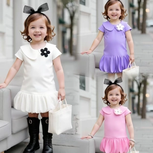 Detail view of girls bubble hem dresses in white, purple and pink with Peter Pan collars