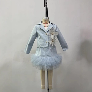 Close-up of light blue girls blazer featuring 3D white floral decor and pearl accents