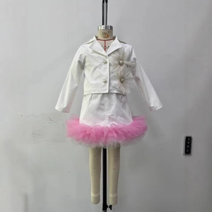 Detail of white blazer with 3D floral pearls and layered pink mesh on a girl suit