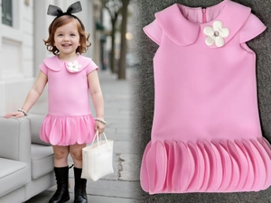 Close-up of pink girls dress with 3D flower collar and tiered petal pleated skirt