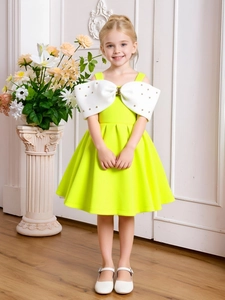 Detail of elegant girls gown with oversized white bow and pearl embellishments