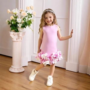 Detailed view of 3D floral petals on the hem of a pink sleeveless girl dress