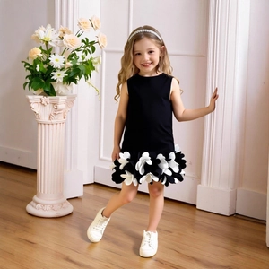 Detailed look at sleeveless black dress with 3D black and white floral ruffle hem for girls