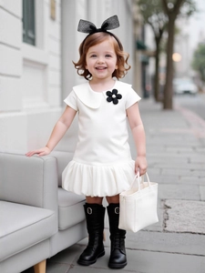 White puff sleeve dress for girls with black flower brooch and Peter Pan collar