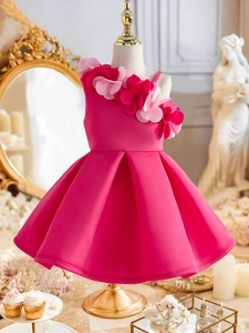 Detail of rose pink flower shoulder girl dress with layered handmade floral embellishments