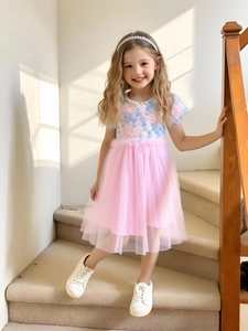Pink tulle princess dress for girls with floral sequins and puffed sleeves shown on model