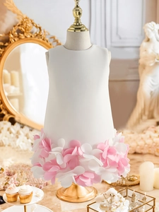 Detail of white sleeveless princess dress with pink floral petal texture on skirt