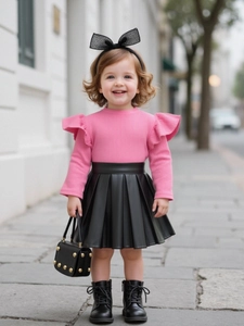 Pink knit long sleeve ruffle top and black pleated faux leather skirt two-piece outfit